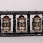 Handcrafted tibetan prayer wheels with wooden frame.