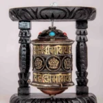 Handcrafted Tibetan single prayer wheel with wooden frame.